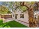 Backyard oasis with a patio, artificial turf, and large tree at 5347 Reardon Ct, North Las Vegas, NV 89031