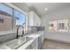 Kitchen features white cabinets, quartz countertops, and a modern farmhouse sink at 5347 Reardon Ct, North Las Vegas, NV 89031