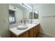 Updated bathroom with double vanity, modern fixtures, and large mirror at 5710 E Tropicana Ave # 2112, Las Vegas, NV 89122