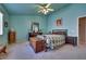 Spacious bedroom with light blue walls, ceiling fan, and a large bed at 5916 Naperville St, Las Vegas, NV 89130