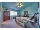 Spacious bedroom with light blue walls, ceiling fan, and a large bed at 5916 Naperville St, Las Vegas, NV 89130