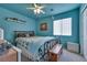 Bedroom with blue walls, ceiling fan, and a comfortable bed at 5916 Naperville St, Las Vegas, NV 89130