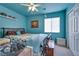 Bedroom with blue walls, ceiling fan, and a comfortable bed at 5916 Naperville St, Las Vegas, NV 89130