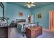 Spacious bedroom with light blue walls, ceiling fan, and a large bed at 5916 Naperville St, Las Vegas, NV 89130