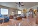 Living room with L-shaped sofa, wood floors, and ceiling fan at 5916 Naperville St, Las Vegas, NV 89130