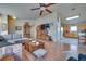 Living room with L-shaped sofa, wood floors, and kitchen view at 5916 Naperville St, Las Vegas, NV 89130