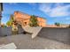 Rear view of the property with a gravel yard and block wall at 644 Chase Tree St, Las Vegas, NV 89144