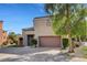 Beautiful two-story home with well-maintained lawn, garden and a two-car garage on a bright sunny day at 644 Chase Tree St, Las Vegas, NV 89144