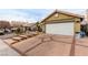 House exterior showcasing a white garage door and brick driveway at 6442 Cedar Breaks Ave, Las Vegas, NV 89156