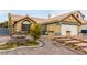 Landscaped front yard with a fountain and brick driveway at 6442 Cedar Breaks Ave, Las Vegas, NV 89156