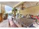 Outdoor patio with a large table, bench and overhead lighting at 6442 Cedar Breaks Ave, Las Vegas, NV 89156