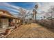 Fenced backyard, lush palm trees, and mature landscape at 6443 Silverfield Dr, Las Vegas, NV 89103