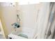 Clean white bathtub and shower combination with built in storage at 6443 Silverfield Dr, Las Vegas, NV 89103