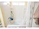 Clean white bathtub and shower combination with built in storage at 6443 Silverfield Dr, Las Vegas, NV 89103