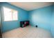 Well-lit bedroom featuring tile floors, a window, and a storage cube organizer at 6443 Silverfield Dr, Las Vegas, NV 89103