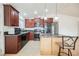 Modern kitchen design featuring dark countertops and dark brown cabinetry with a kitchen island at 6443 Silverfield Dr, Las Vegas, NV 89103