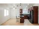 Open kitchen features an island with seating and updated appliances at 6443 Silverfield Dr, Las Vegas, NV 89103