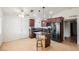 Open kitchen with stainless steel appliances, granite counters and a central island at 6443 Silverfield Dr, Las Vegas, NV 89103