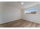 Simple bedroom with wood floors and large window at 705 N Torrey Pines Dr, Las Vegas, NV 89107