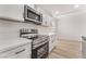 Stylish kitchen with white cabinets, quartz countertops, and stainless steel appliances at 705 N Torrey Pines Dr, Las Vegas, NV 89107