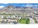 An aerial view showcases a community with mountain views and well-maintained lawns and landscaping at 725 Pacific Cascades Dr, Henderson, NV 89012