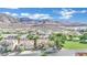 Scenic aerial view of a neighborhood nestled against majestic mountains and open green spaces at 725 Pacific Cascades Dr, Henderson, NV 89012