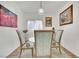 Bright dining room features a glass table with seating for four, natural light, and modern decor at 725 Pacific Cascades Dr, Henderson, NV 89012