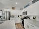 Bright kitchen featuring white cabinets, stainless steel appliances and stone countertops at 725 Pacific Cascades Dr, Henderson, NV 89012
