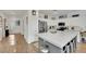 Open kitchen design with a large center island, stone countertops, stainless steel appliances, and white cabinetry at 725 Pacific Cascades Dr, Henderson, NV 89012