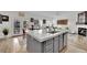 Open floor plan, kitchen island with dishwasher and sink, living room fireplace at 725 Pacific Cascades Dr, Henderson, NV 89012