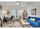 Inviting living room with a comfortable blue sofa, large windows, and a stylish decor at 725 Pacific Cascades Dr, Henderson, NV 89012
