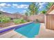 Secluded pool area surrounded by lush greenery and a brick privacy wall at 725 Pacific Cascades Dr, Henderson, NV 89012