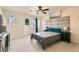 Main bedroom with ceiling fan, large bed, and access to balcony at 7652 Calico Fields St, Las Vegas, NV 89149