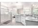 Bright bathroom features double sinks with granite counters and a glass enclosed shower at 7733 Rosebark Cliffs St, North Las Vegas, NV 89084