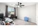 Bedroom boasts a ceiling fan, neutral walls and a large window at 7733 Rosebark Cliffs St, North Las Vegas, NV 89084