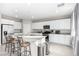 Modern kitchen with stainless steel appliances, granite countertops, and barstool seating at 7733 Rosebark Cliffs St, North Las Vegas, NV 89084