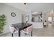 Modern dining area with four pink chairs and view into kitchen at 7908 Mountain Point Ave, Las Vegas, NV 89131