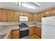 Modern kitchen with wood cabinets, granite counters, and stainless steel appliances at 7950 W Flamingo Rd # 1041, Las Vegas, NV 89147