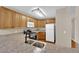 Kitchen with wood cabinets, granite counters, and appliances at 7950 W Flamingo Rd # 1041, Las Vegas, NV 89147