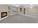 Living room with fireplace, carpet, and sliding glass door at 7950 W Flamingo Rd # 1041, Las Vegas, NV 89147