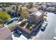 Aerial view of a home featuring a gravel backyard with a fire pit, umbrella, and various seating options at 8736 Summoners Ct, Las Vegas, NV 89139