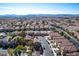 Aerial view showing a neighborhood with houses, streets and the mountains in the distance at 8736 Summoners Ct, Las Vegas, NV 89139