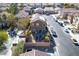 Aerial view of a home featuring a gravel backyard with a fire pit, umbrella, and various seating options at 8736 Summoners Ct, Las Vegas, NV 89139