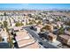 Aerial view showing a neighborhood with houses, streets and the Las Vegas Strip in the distance at 8736 Summoners Ct, Las Vegas, NV 89139