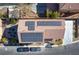 Overhead view of home featuring a tile roof, solar panels, and a spacious driveway at 8736 Summoners Ct, Las Vegas, NV 89139