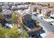 Aerial view of a home featuring a gravel backyard with a fire pit, umbrella, and various seating options at 8736 Summoners Ct, Las Vegas, NV 89139