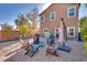 Enjoy the outdoors in this gravel backyard with a firepit, umbrella and various seating options at 8736 Summoners Ct, Las Vegas, NV 89139