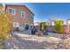 Enjoy the outdoors in this gravel backyard with a firepit, umbrella and various seating options at 8736 Summoners Ct, Las Vegas, NV 89139