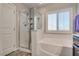 Modern bathroom featuring a glass enclosed shower and a large soaking tub with shutters at 8736 Summoners Ct, Las Vegas, NV 89139