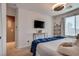 Bright bedroom featuring white walls, TV, and blue accent blanket at 8736 Summoners Ct, Las Vegas, NV 89139